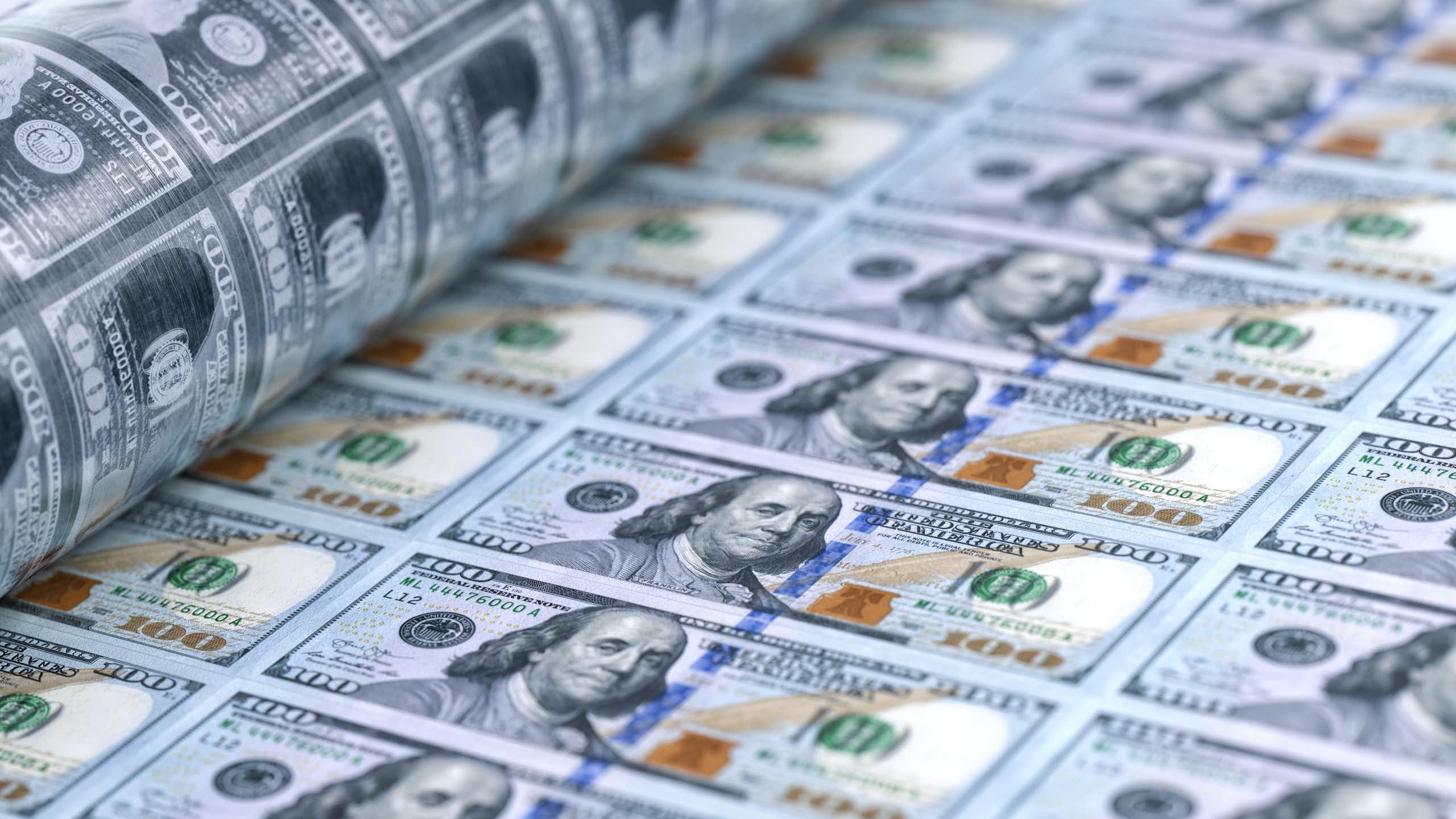 A sheet of 100 dollar bills being printed.