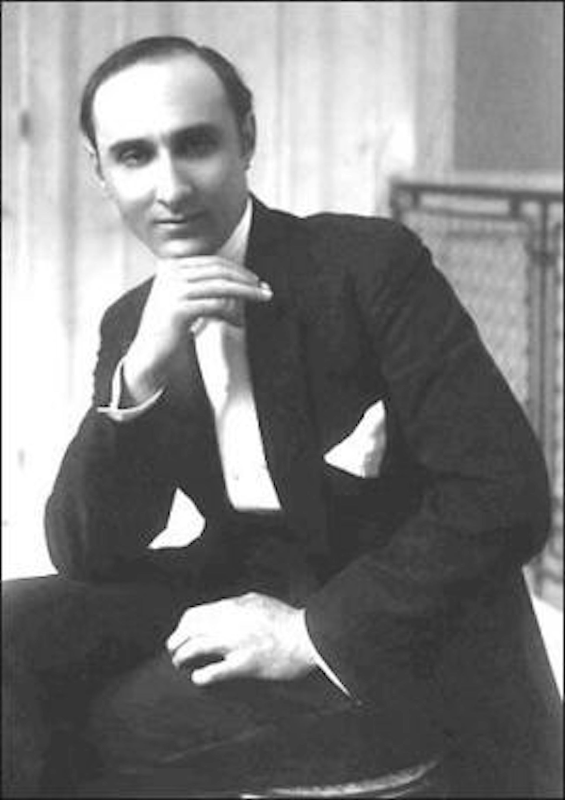 Black and white photo of man in shirt and tie.