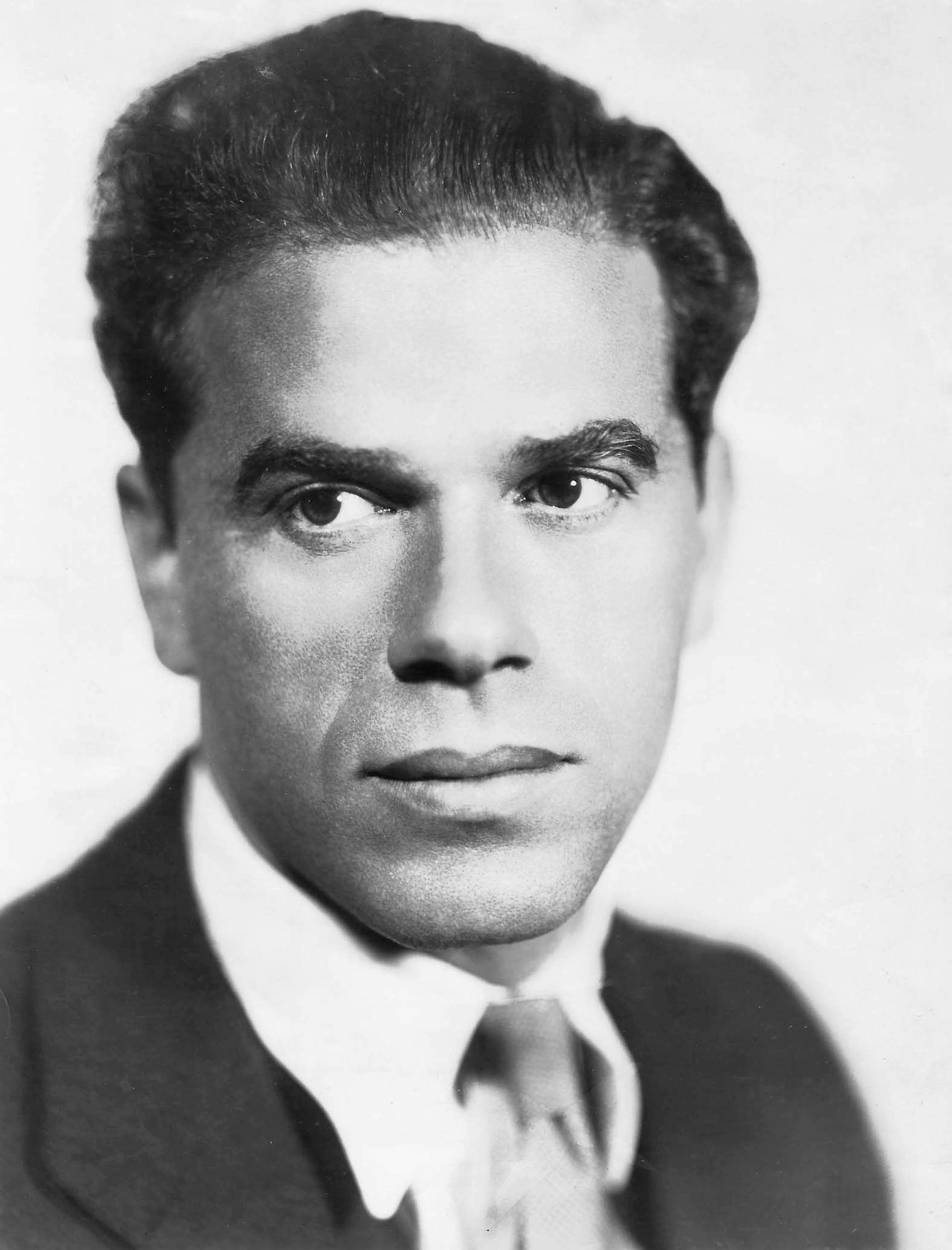 Portrait black and white photo of man in shirt and tie.