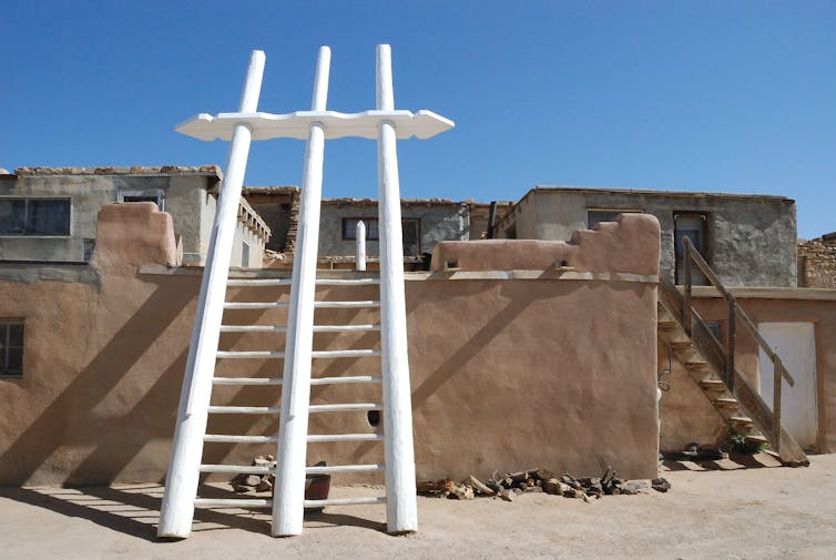 The Seventeenth-century Pueblo chief who fought for independence from colonial rule – lengthy prior to the American Revolution 1 A large wooden ladder with three poles, painted white, leans against an adobe wall under a bright blue sky.