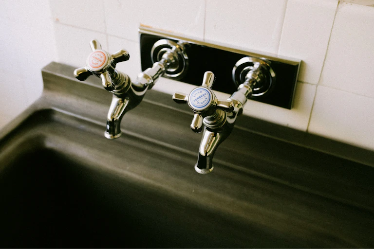 A sink with red and blue taps