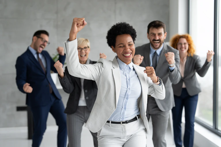 Happy colleagues making celebratory gestures.