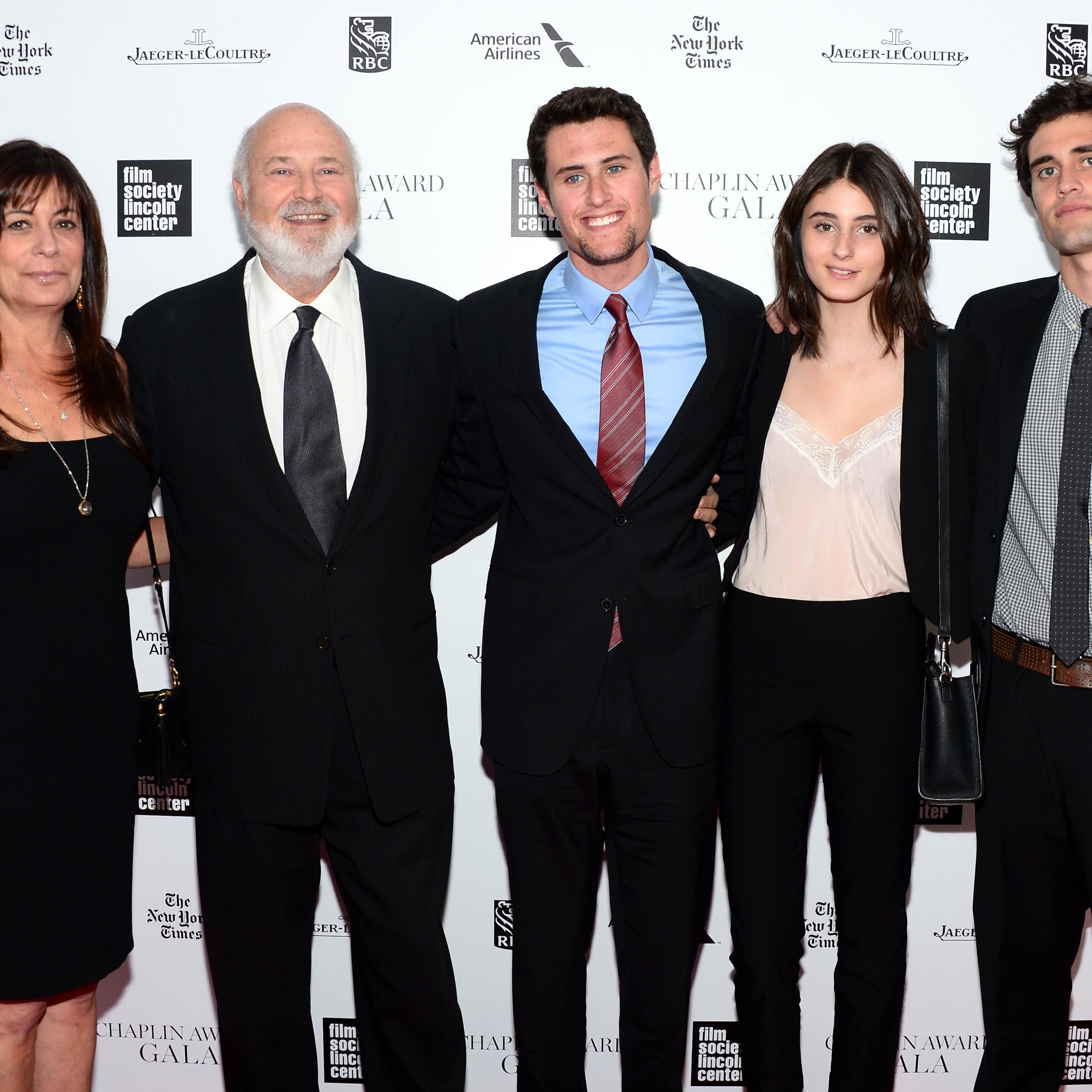 Five people in dressy attire pose for a family photo that includes Rob Reiner.