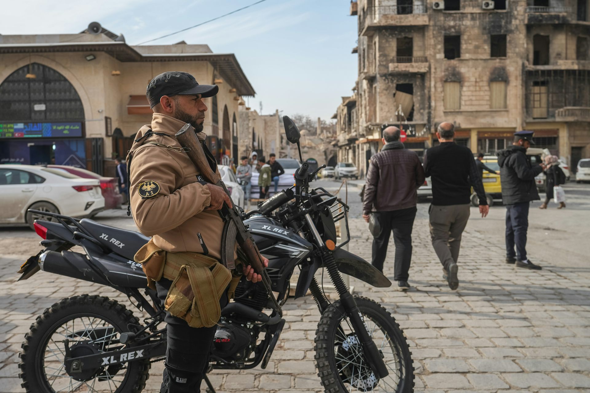 A member of Syria's internal security forces stands guard on the streets of Aleppo.