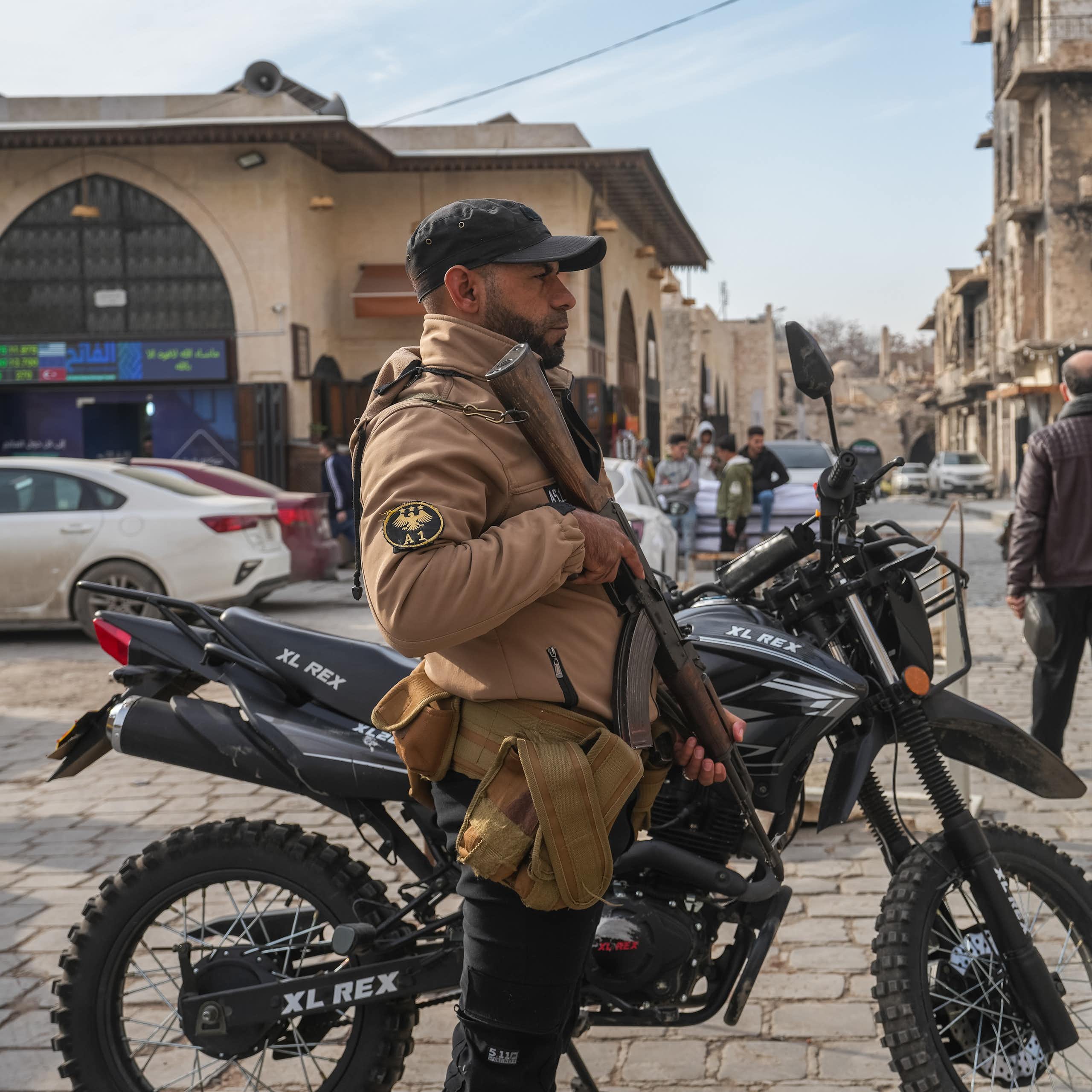 A member of Syria's internal security forces stands guard on the streets of Aleppo.