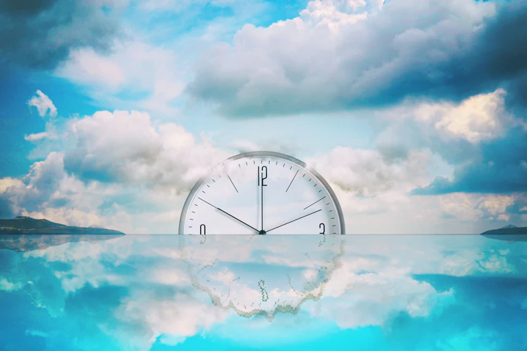Clock sinking into the sea on the horizon
