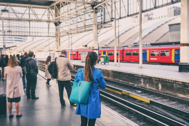 commuters waiting for a train in a uk station