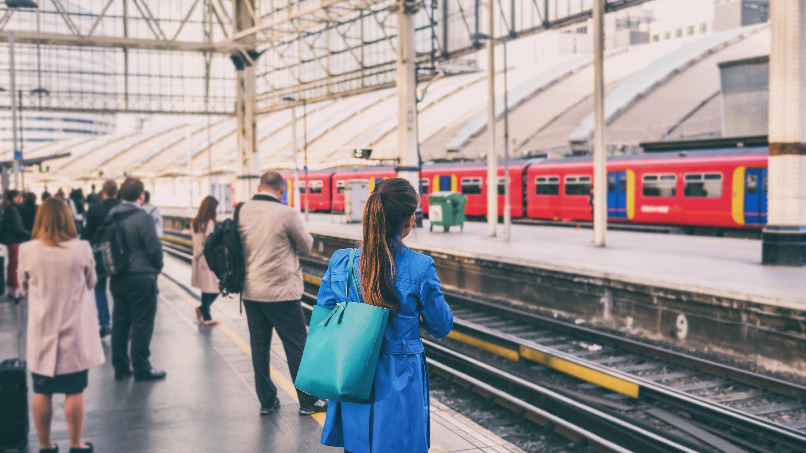 commuters waiting for a train in a uk station