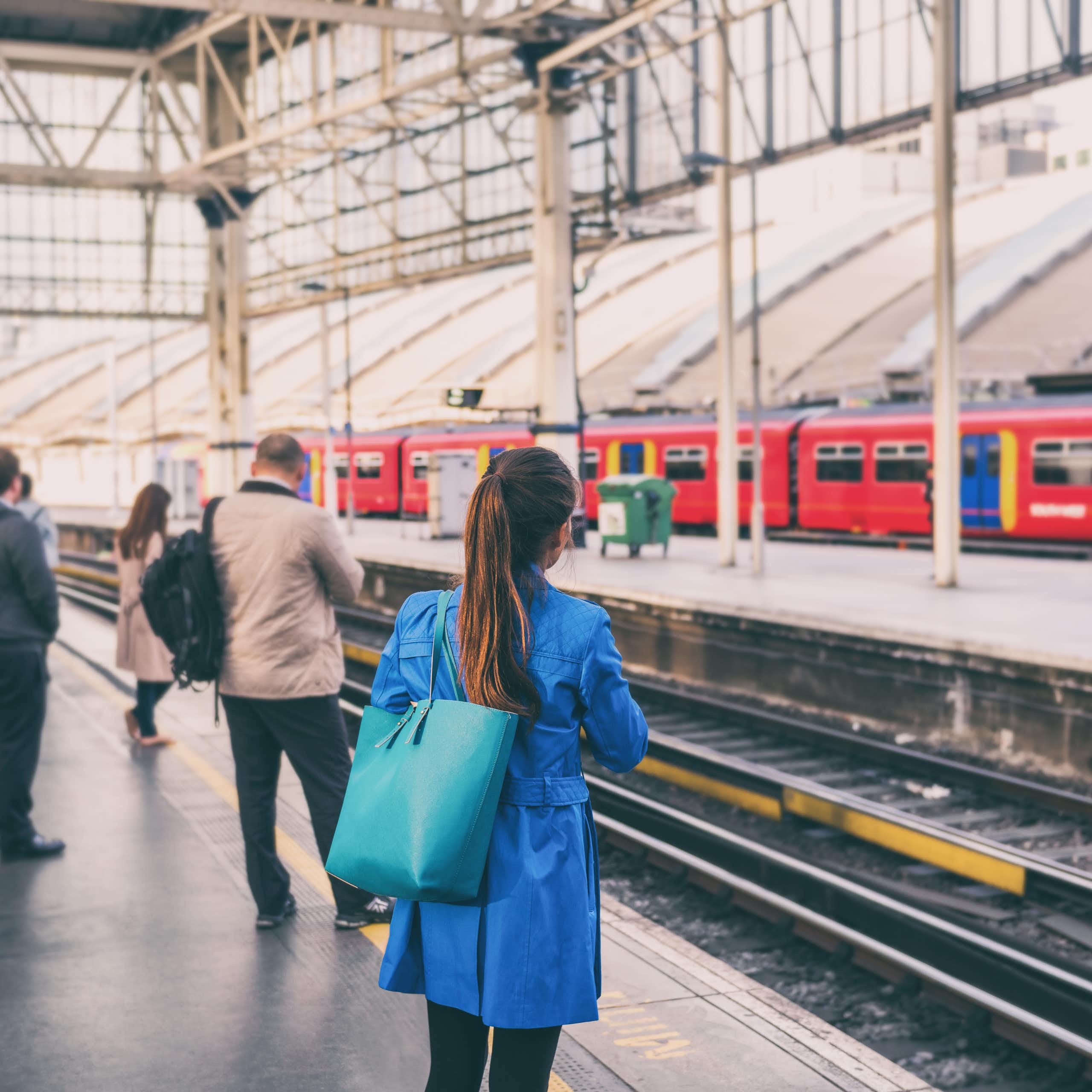 commuters waiting for a train in a uk station