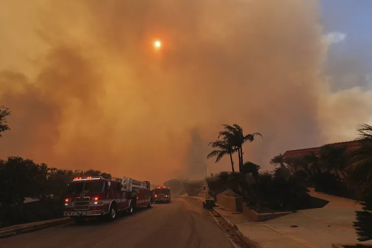 A neighborhood with smoke in the air.