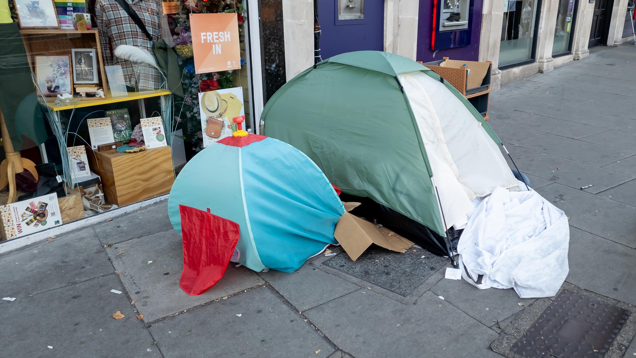 An adult and child sized tent on a street in the UK