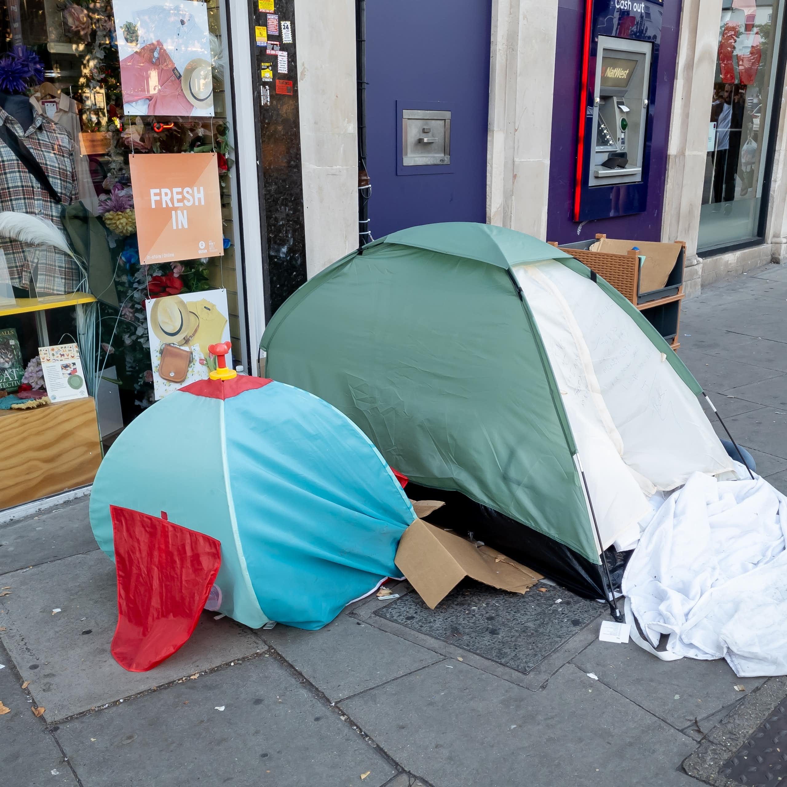 An adult and child sized tent on a street in the UK