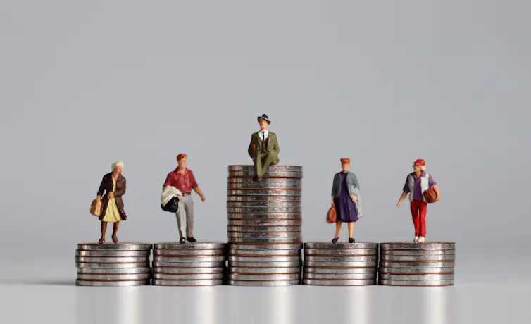 Piles of coins at different heights with tiny figurines of people on top of them