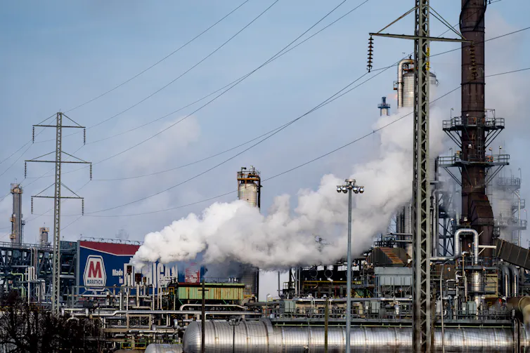 White smoke billows from industrial complex