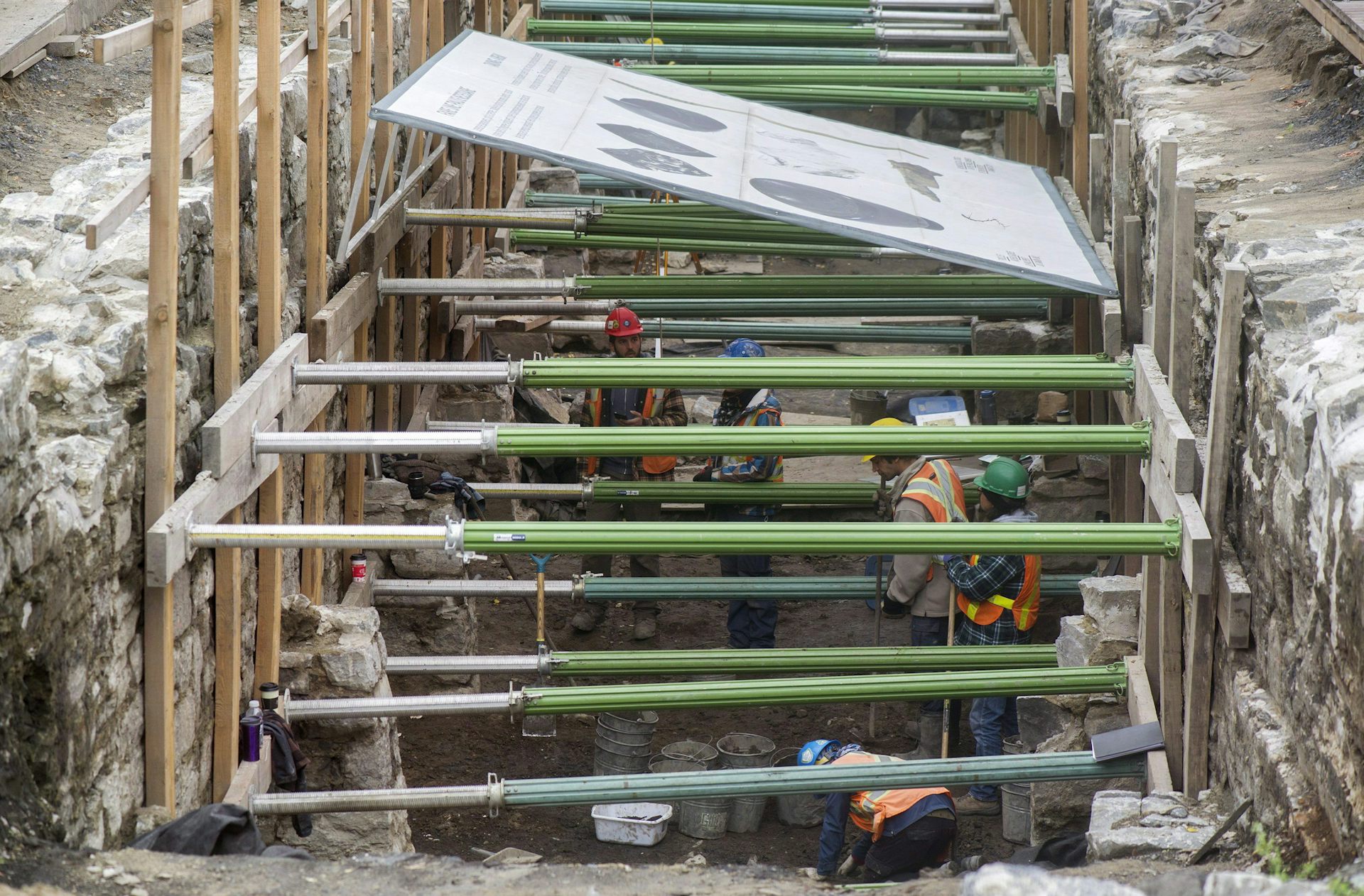 people digging at a work site
