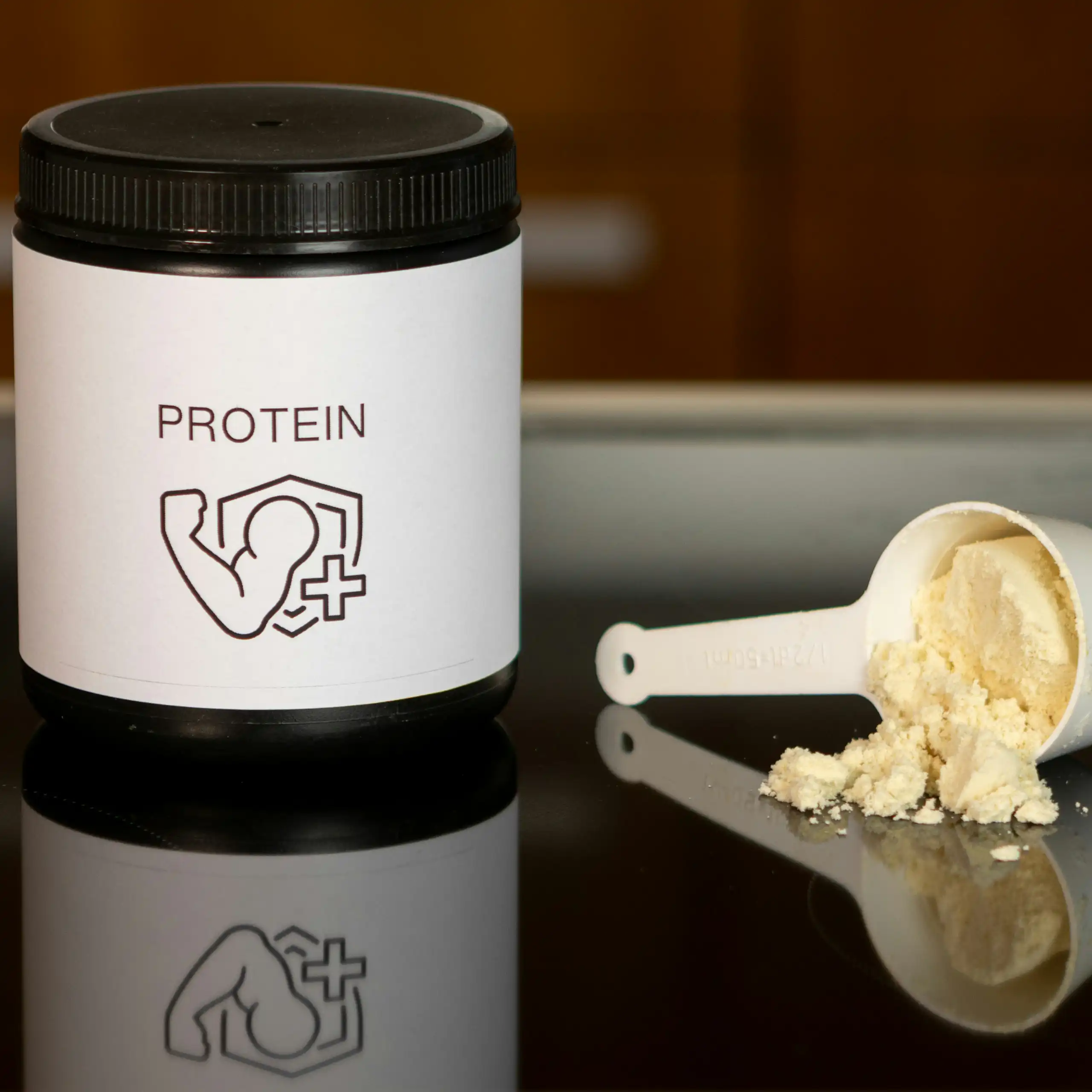 A container of protein powder and a scoop of protein powder