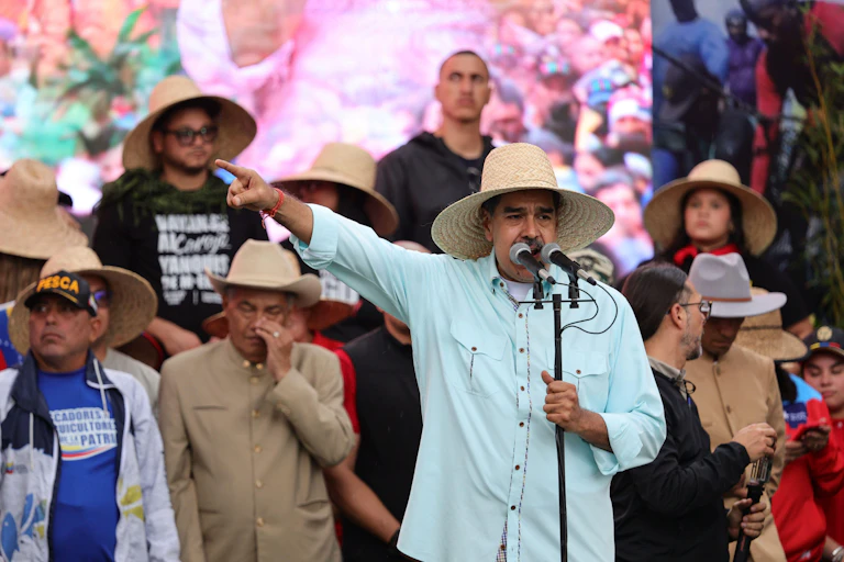 Venezuelan president, Nicolás Maduro, gestures to the crowd as he gives a speech.
