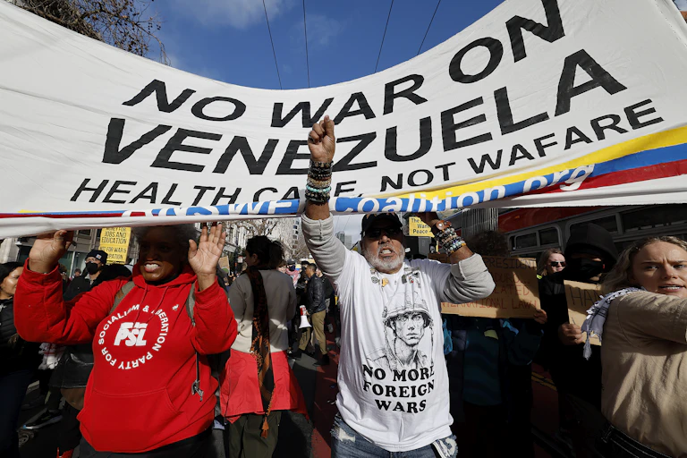 Demonstrators in San Francisco march holding a banner that reads: 'no war on Venezuela'.