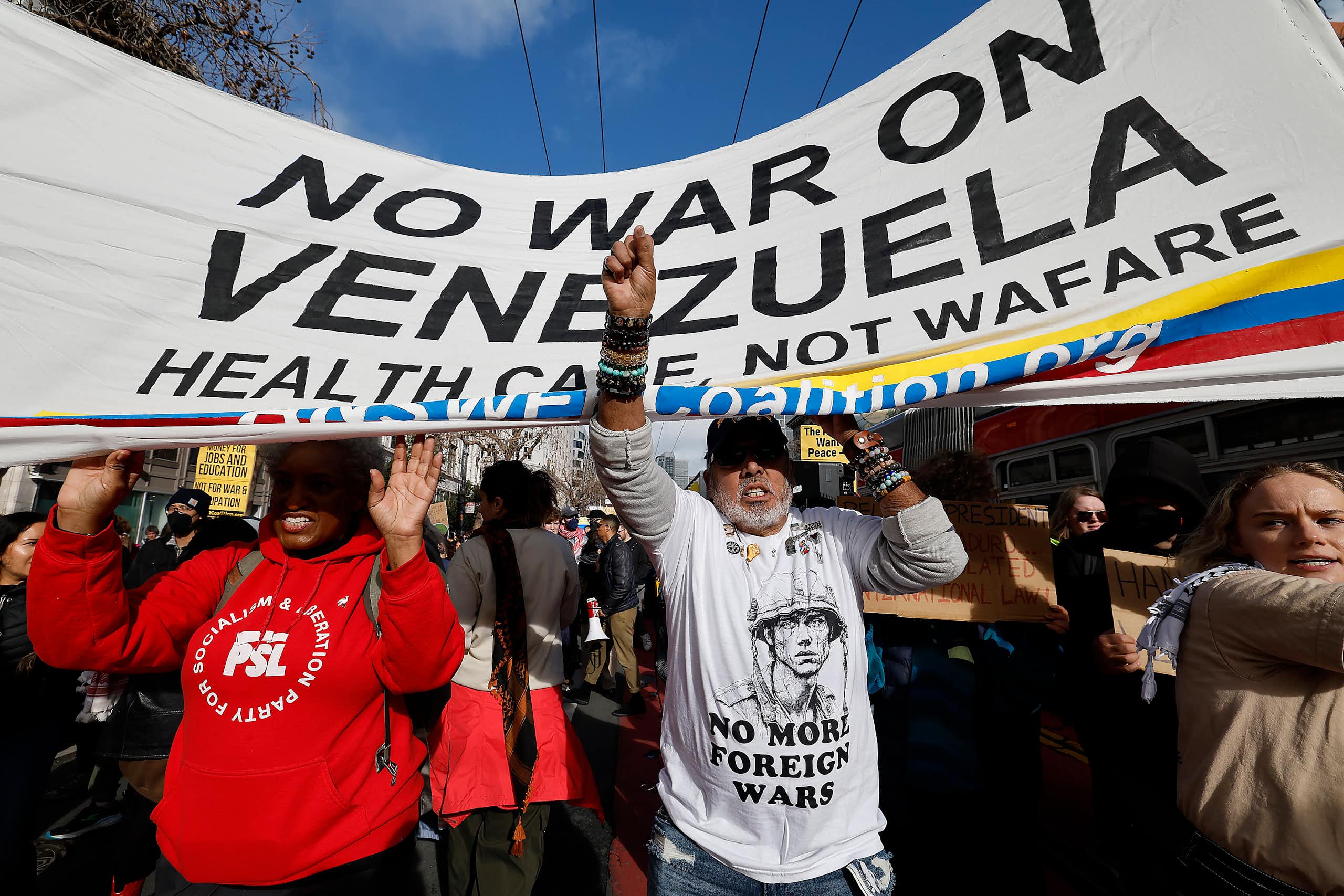 Demonstrators in San Francisco march holding a banner that reads: 'no war on Venezuela'.