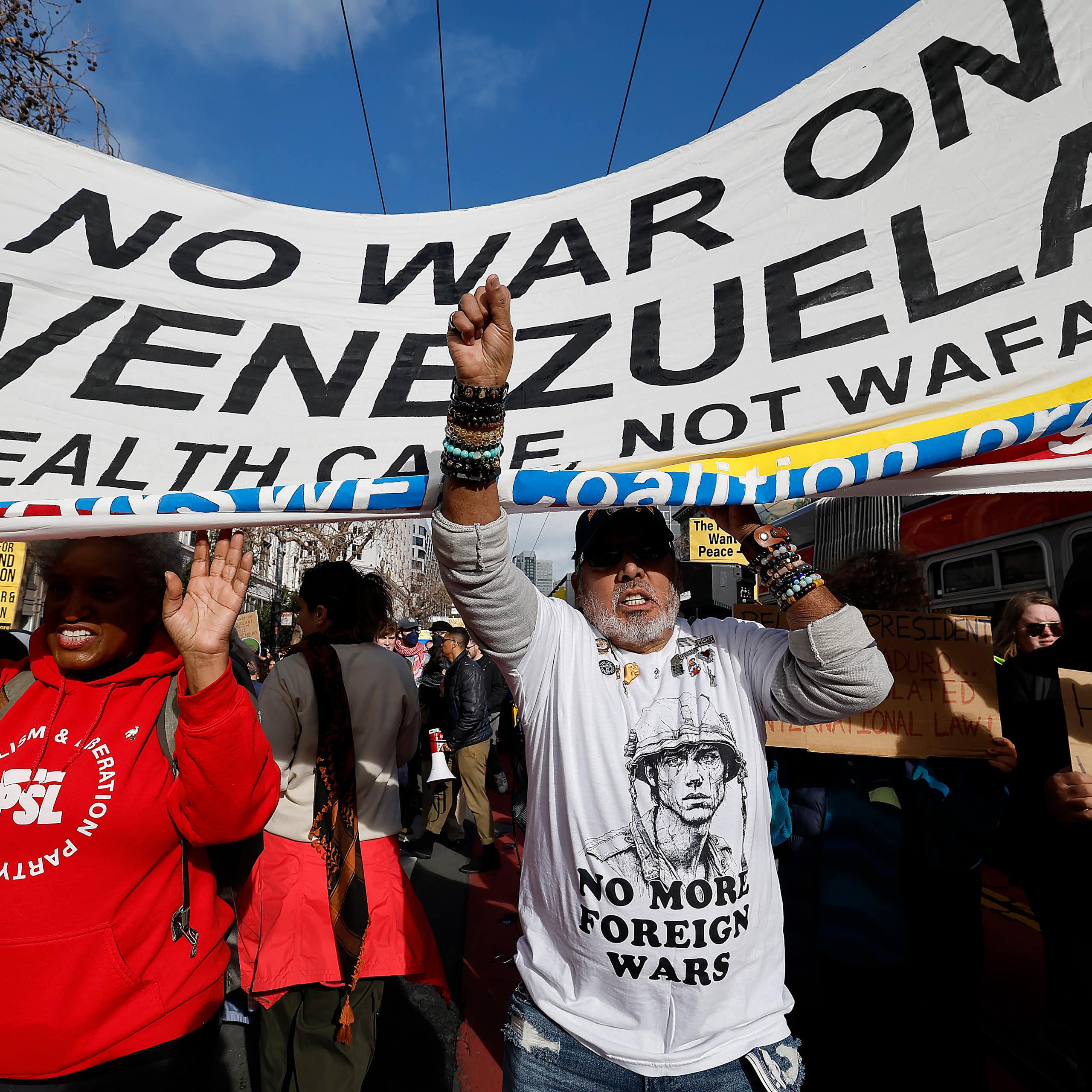 Demonstrators in San Francisco march holding a banner that reads: 'no war on Venezuela'.