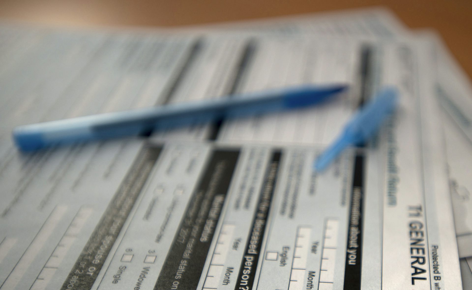 Close up of a pen sitting on top of tax forms