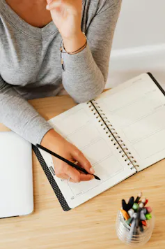 A person writing in a notebook
