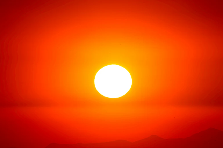 A bright orange setting sun.