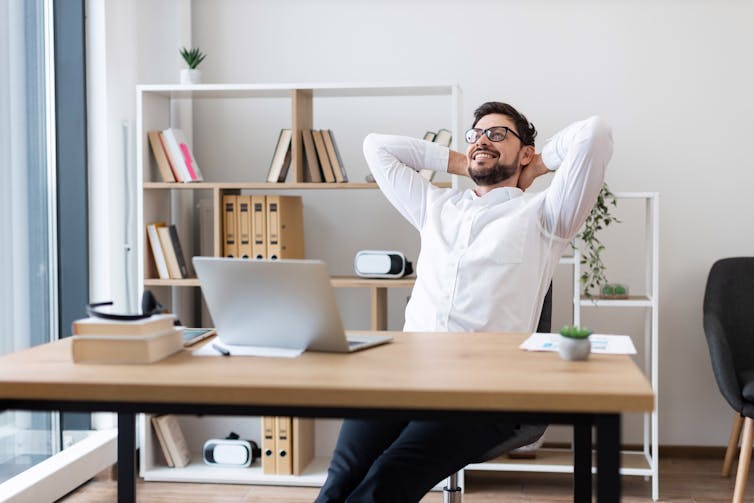 Man looking content at workspace.