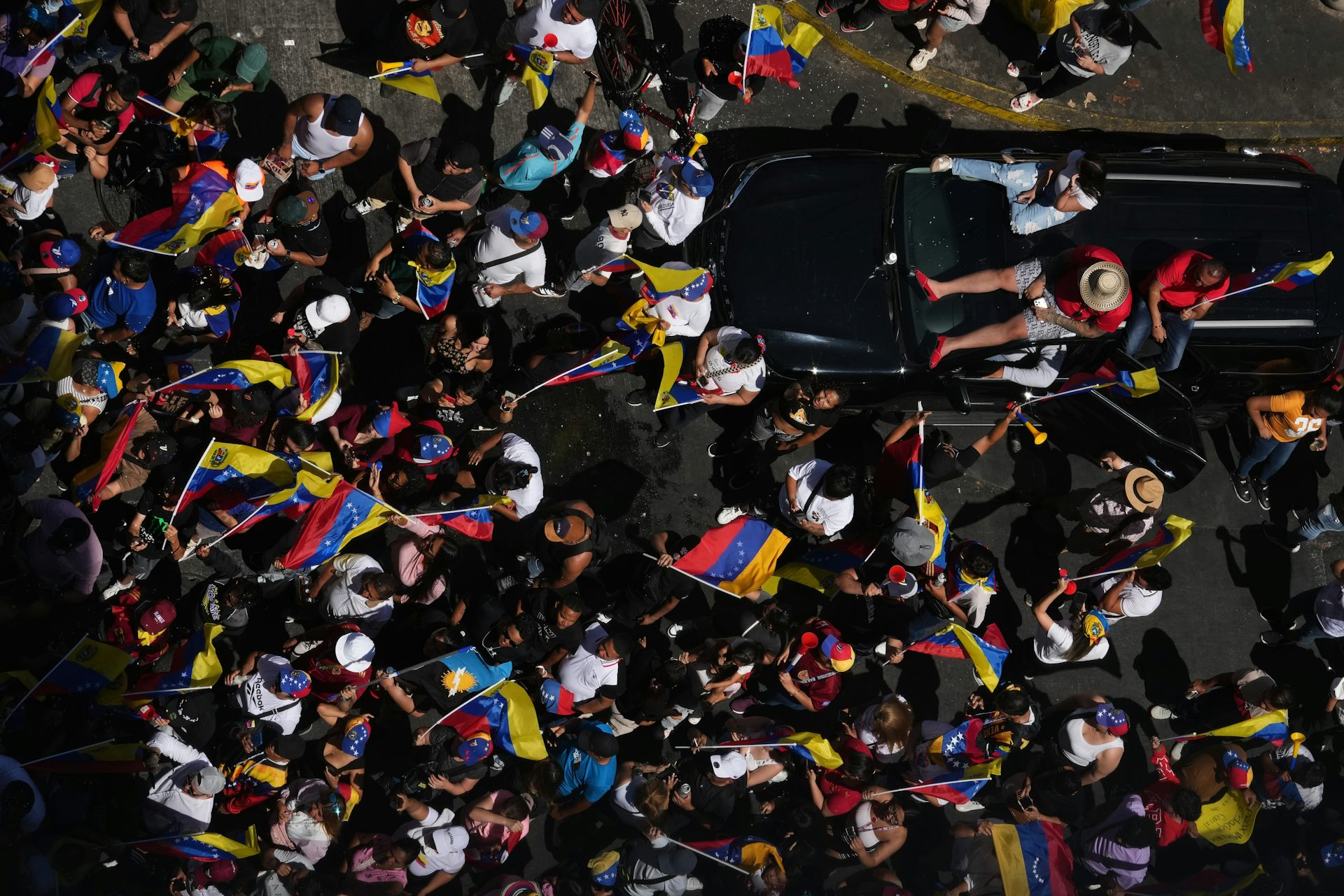 people wave flags in a mass celebration