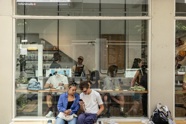 Shoppers sitting outside a cafe in Melbourne