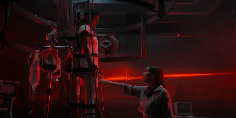 Two characters in an eerie red world.