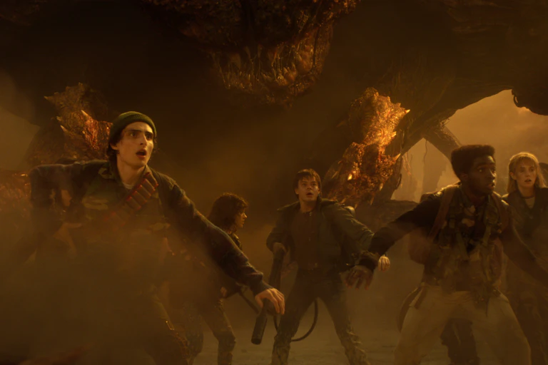 The characters of Stranger Things in an eerie dusty world.