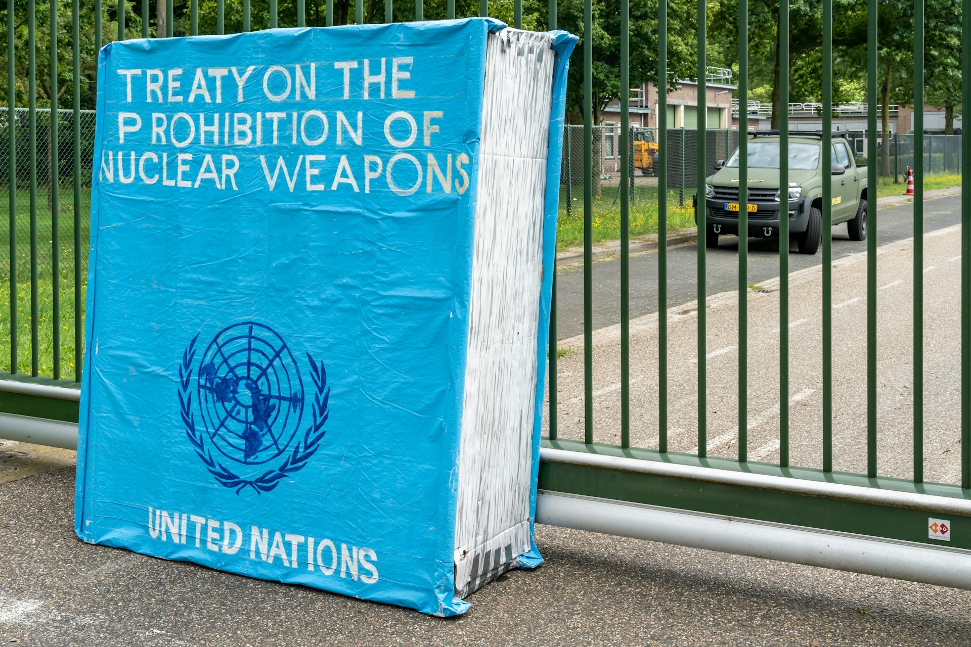 A big, book-shaped dummy titled 'Treaty on the prohibition of nuclear weapons' left by peace activists outside a dutch military air base.