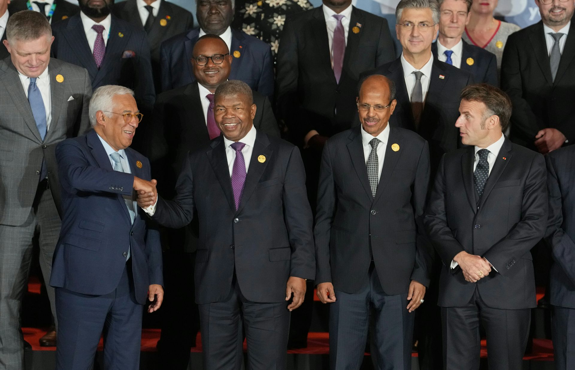 A group of white and black men pose for a photo.