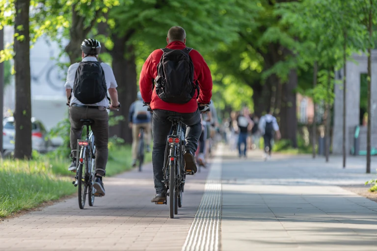 Two cyclists in a city cycle lane.