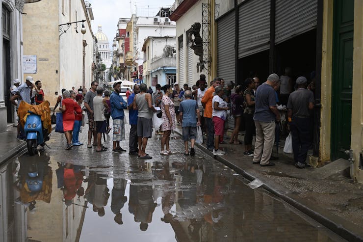 A group of people stand on the street