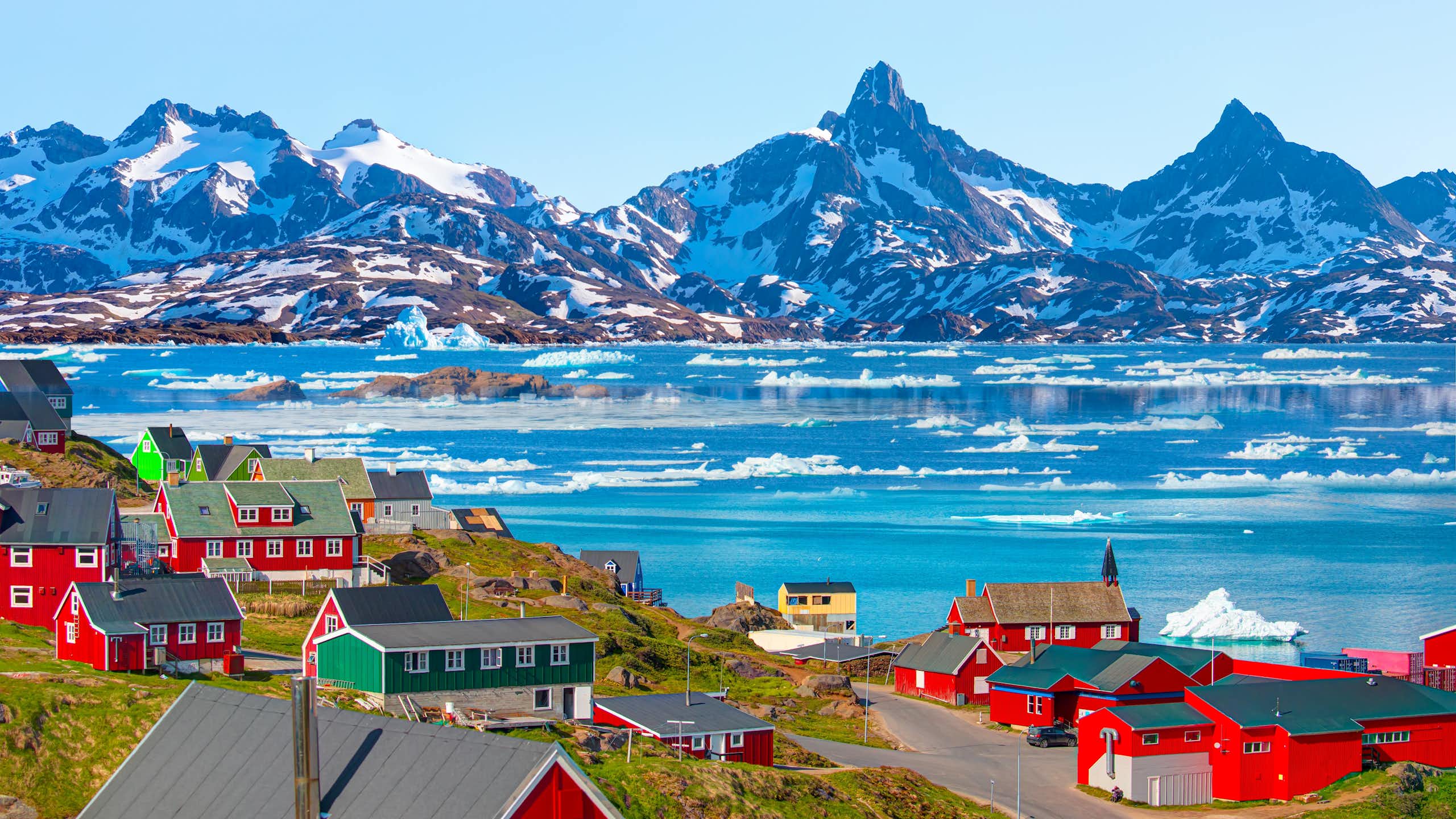 The village of Tasiilaq set against a mountainous backdrop.