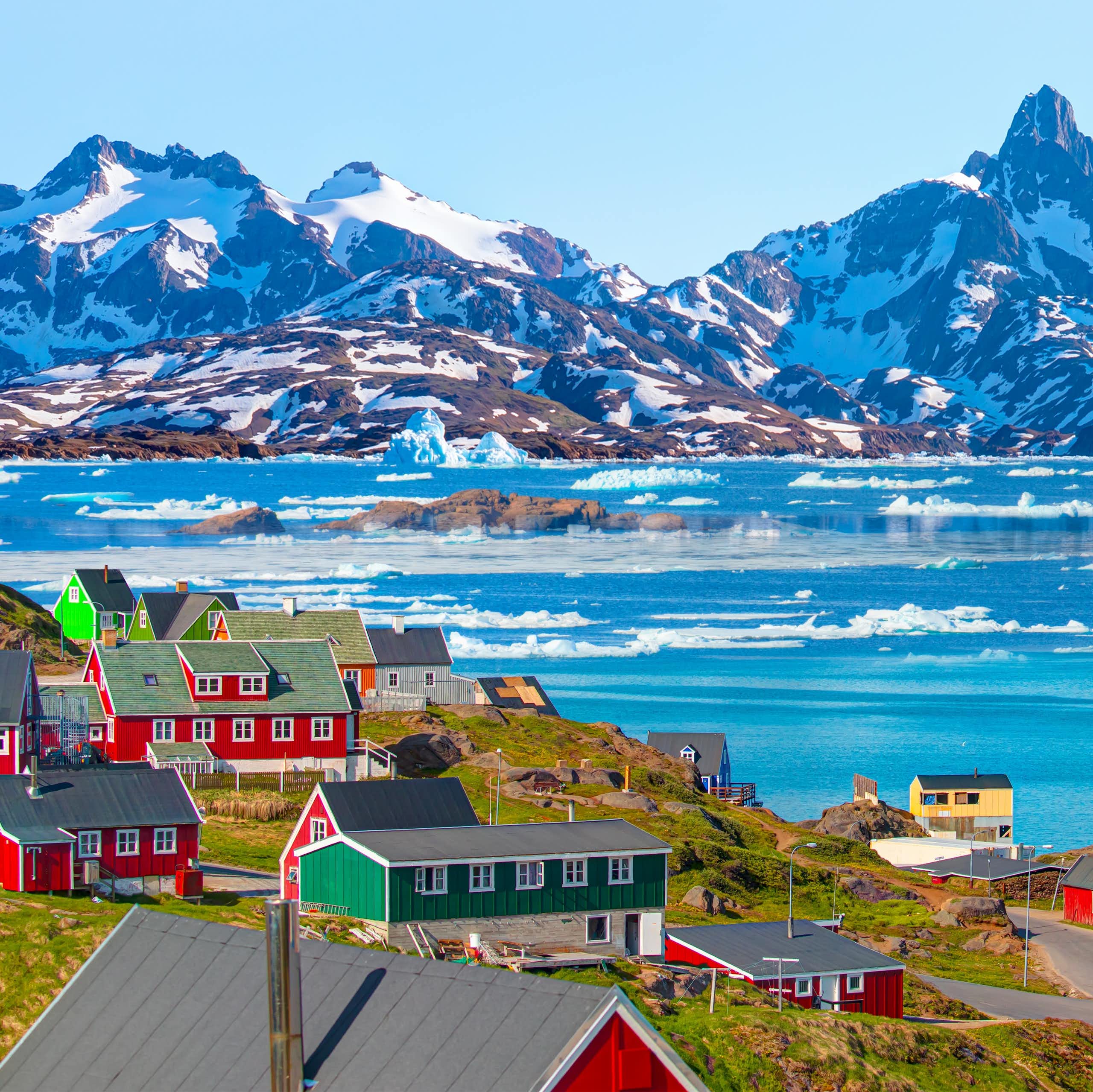 The village of Tasiilaq set against a mountainous backdrop.