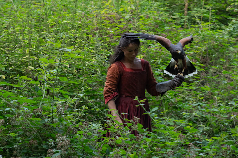 Jessie Buckley holding a hawk