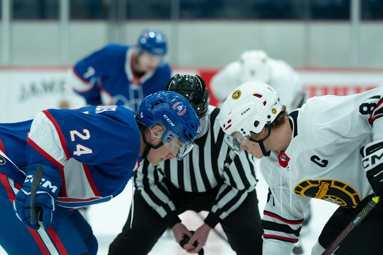 Still from the show: the hockey teams on the ice.