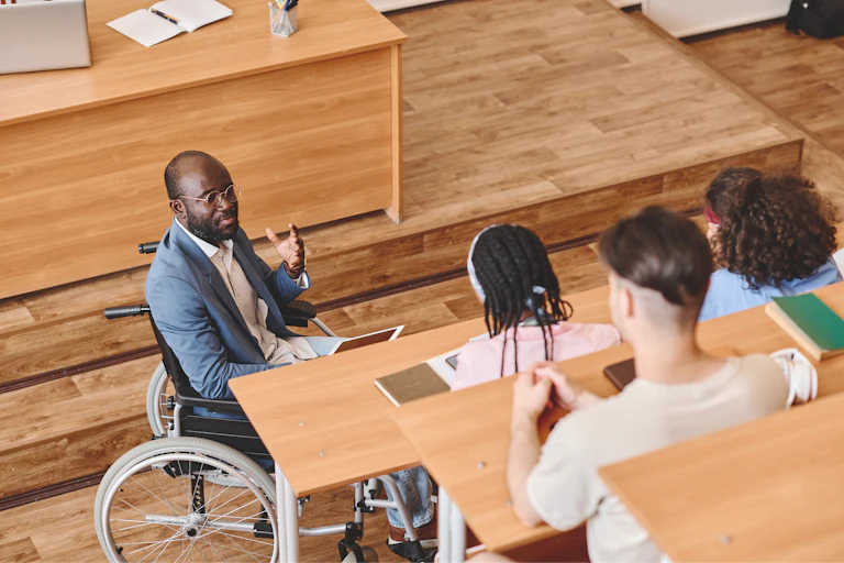 Academic in wheelchair delivering lecture