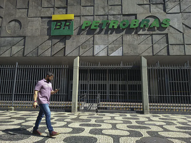 A man walks past the headquarters of a Petrobras building.