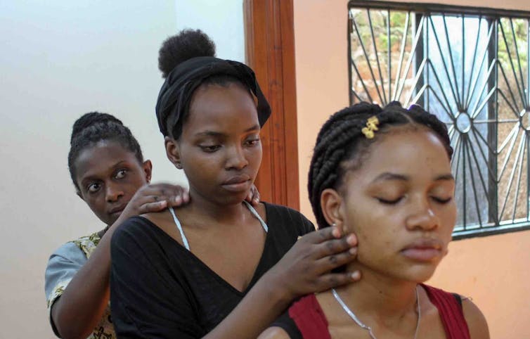 Local weather storytelling steadily ignores younger other folks – arts-based analysis can alternate that 1 Three young women in a line, touching each other's shoulders