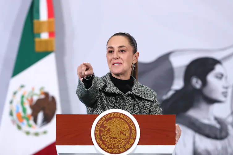 Claudia Sheinbaum stood at a lectern pointing.
