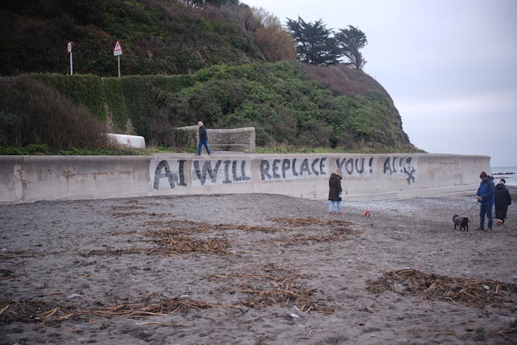 Graffiti on wall, which reads: 'AI will replace you.'