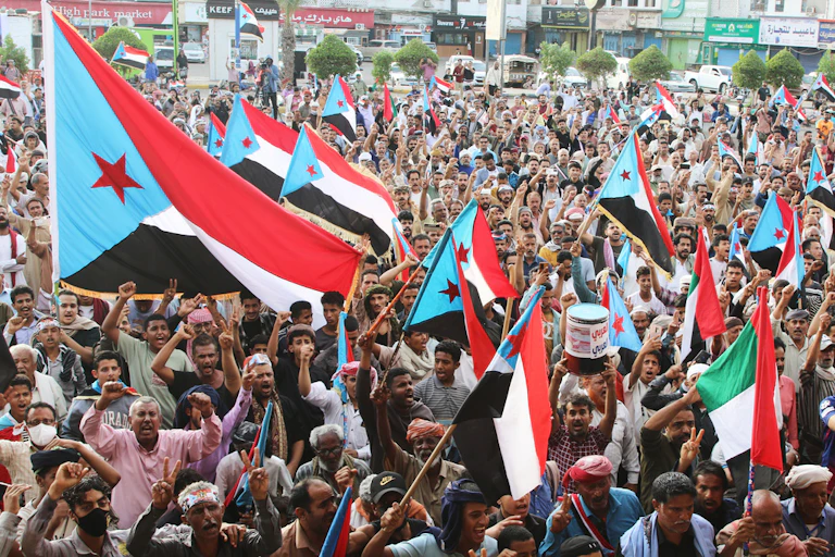 Rallygoers waves flags during a protest.