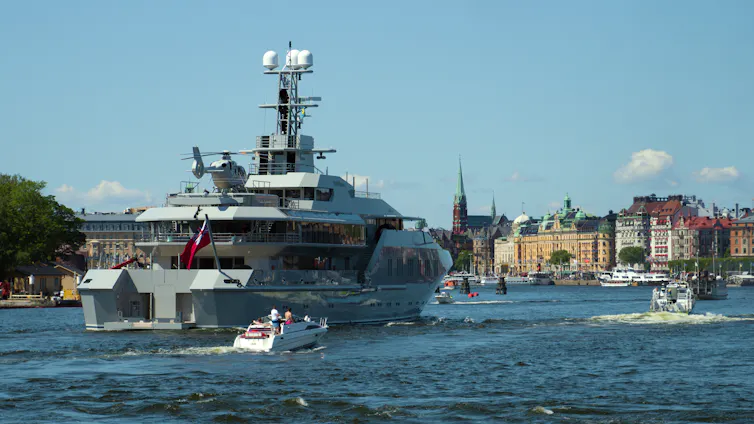 A superyacht with helicopter on board heads into Stockholm's harbour.