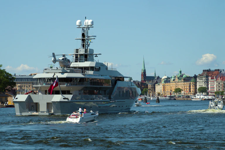 A superyacht with helicopter on board heads into Stockholm's harbour.