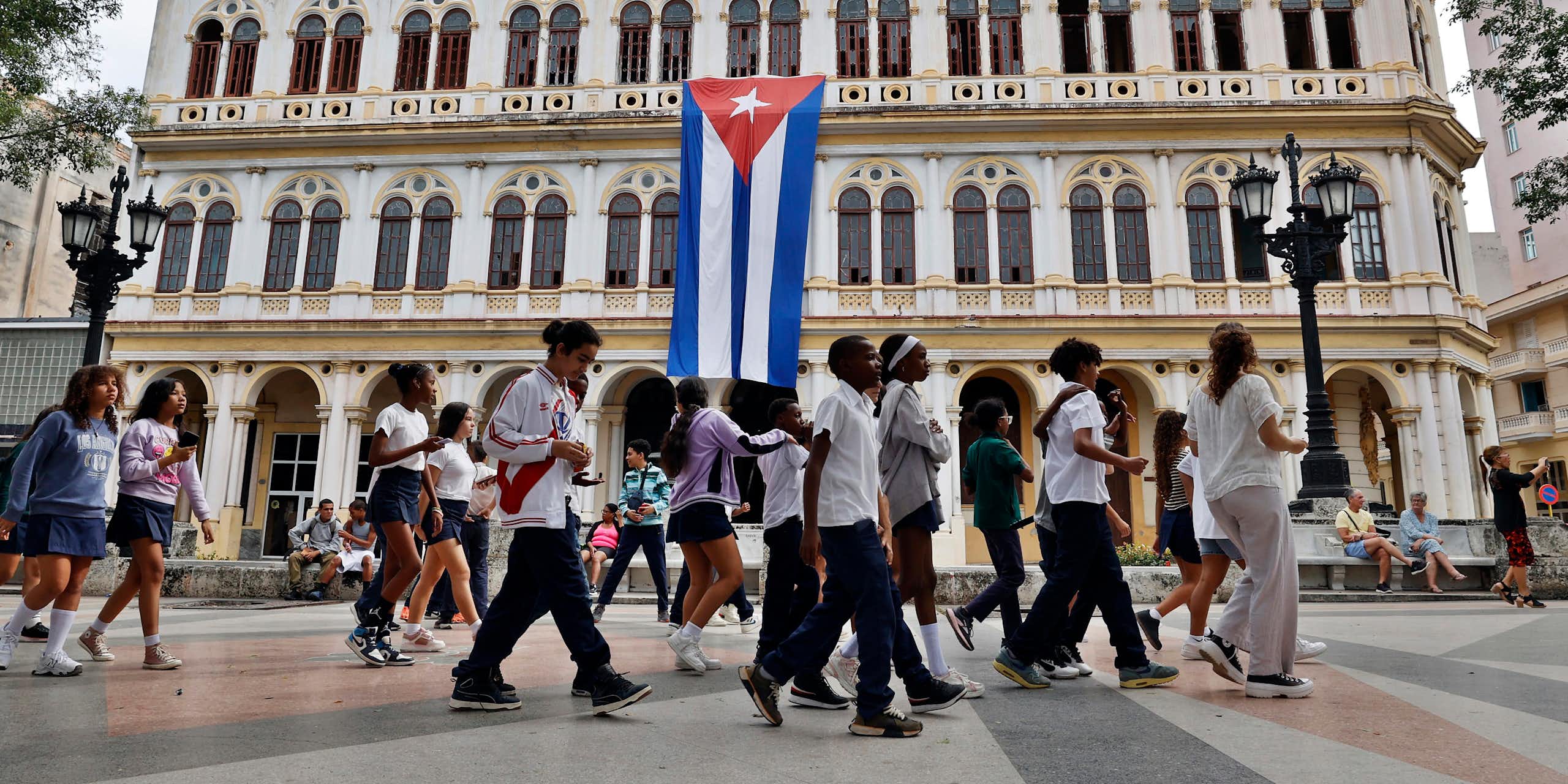 People walk through a park in Havana.