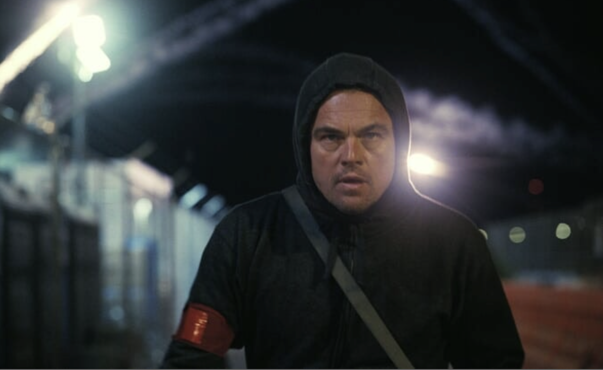  A man dressed in cat-burglar black at night looking determined.